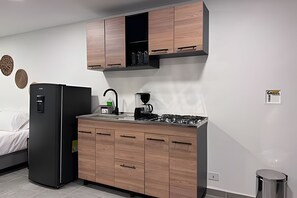Fridge, microwave, coffee/tea maker, cookware/dishes/utensils