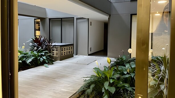 A modern interior with a wooden floor, a seating area, and potted plants. - Charming loft in the center (Medellín)