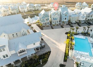 Enjoy stunning ocean views from your balcony in one of our beachfront villas, featuring a pool area with sun loungers.