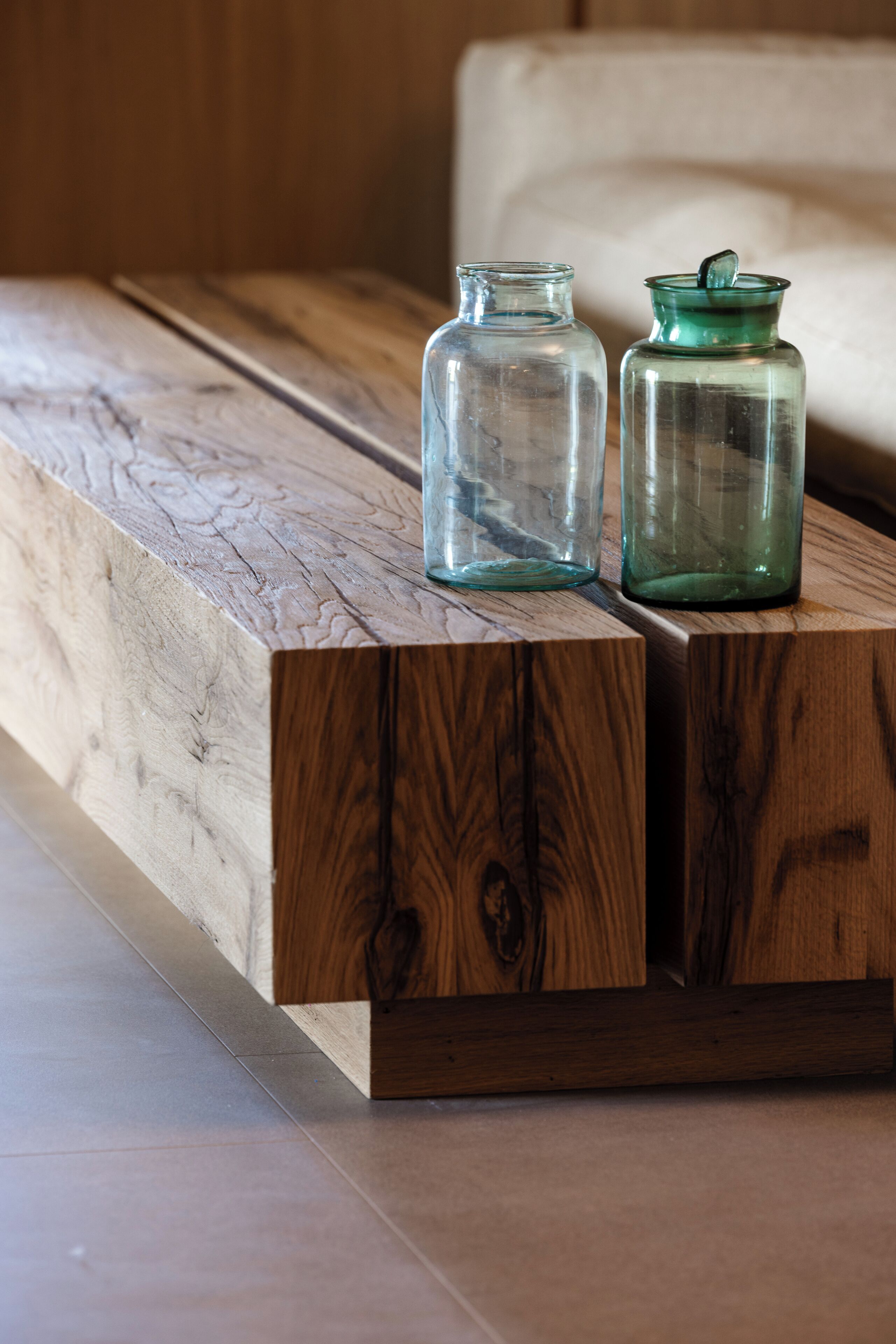 Two glass jars on a wooden platform.