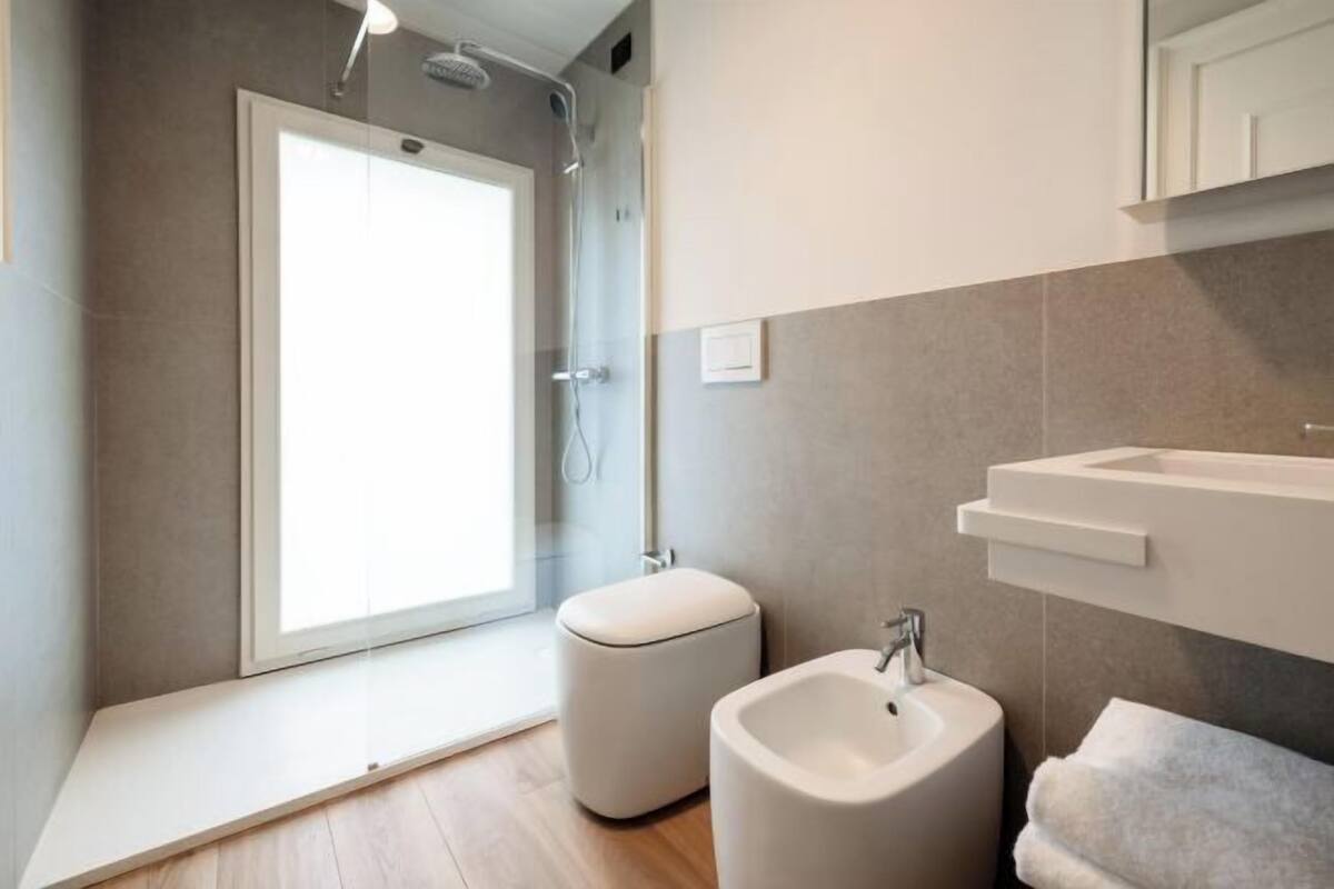Shower, rainfall showerhead, designer toiletries, hair dryer