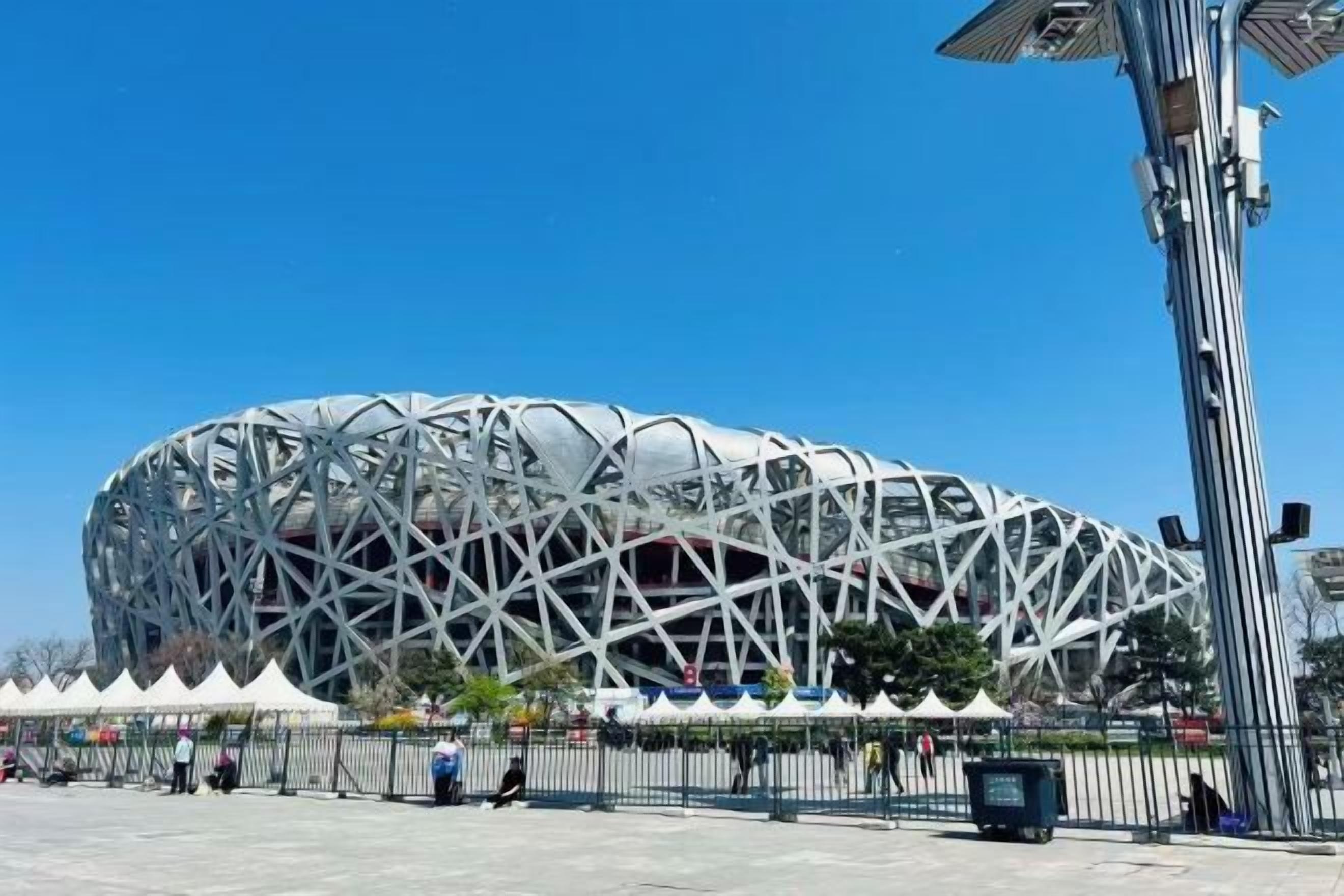 A large, modern stadium with a distinctive geometric design.