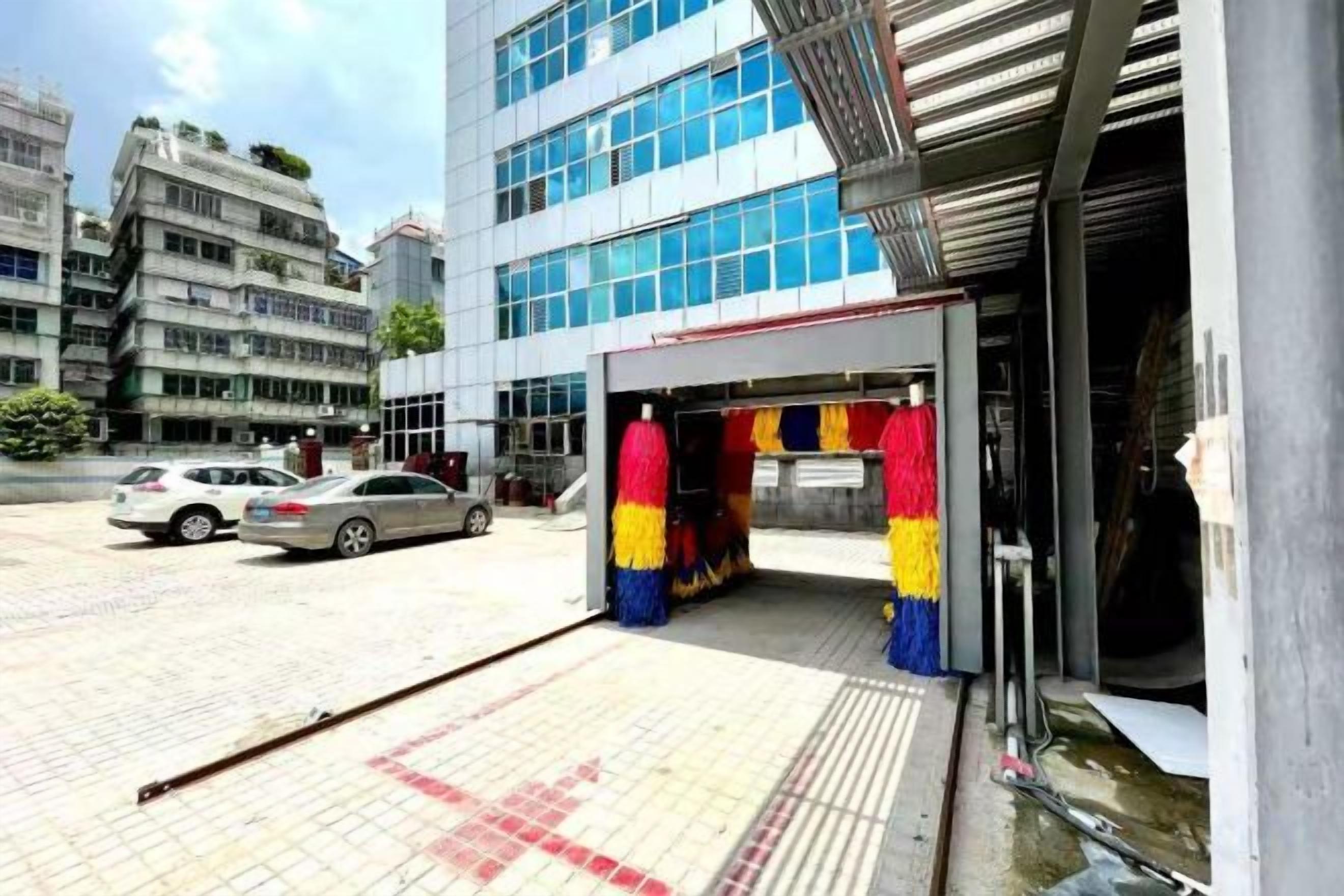 A building entrance with a covered area and a ramp leading to the entrance.