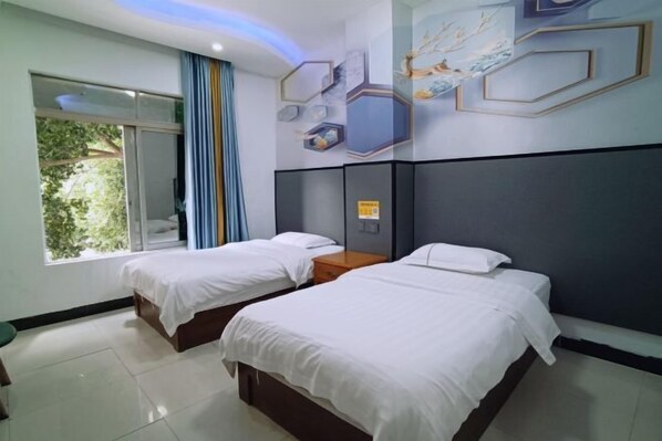 A hotel room with two beds, a large window with curtains, a wall with hexagonal decor, and a ceiling with recessed lighting. - Fogang Xingshu Fashion Hotel (Fogang)