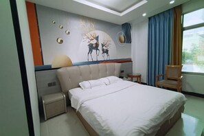 A bedroom with a large bed, a bedside table, a chair, and a wall mural. - Fogang Xingshu Fashion Hotel (Fogang)