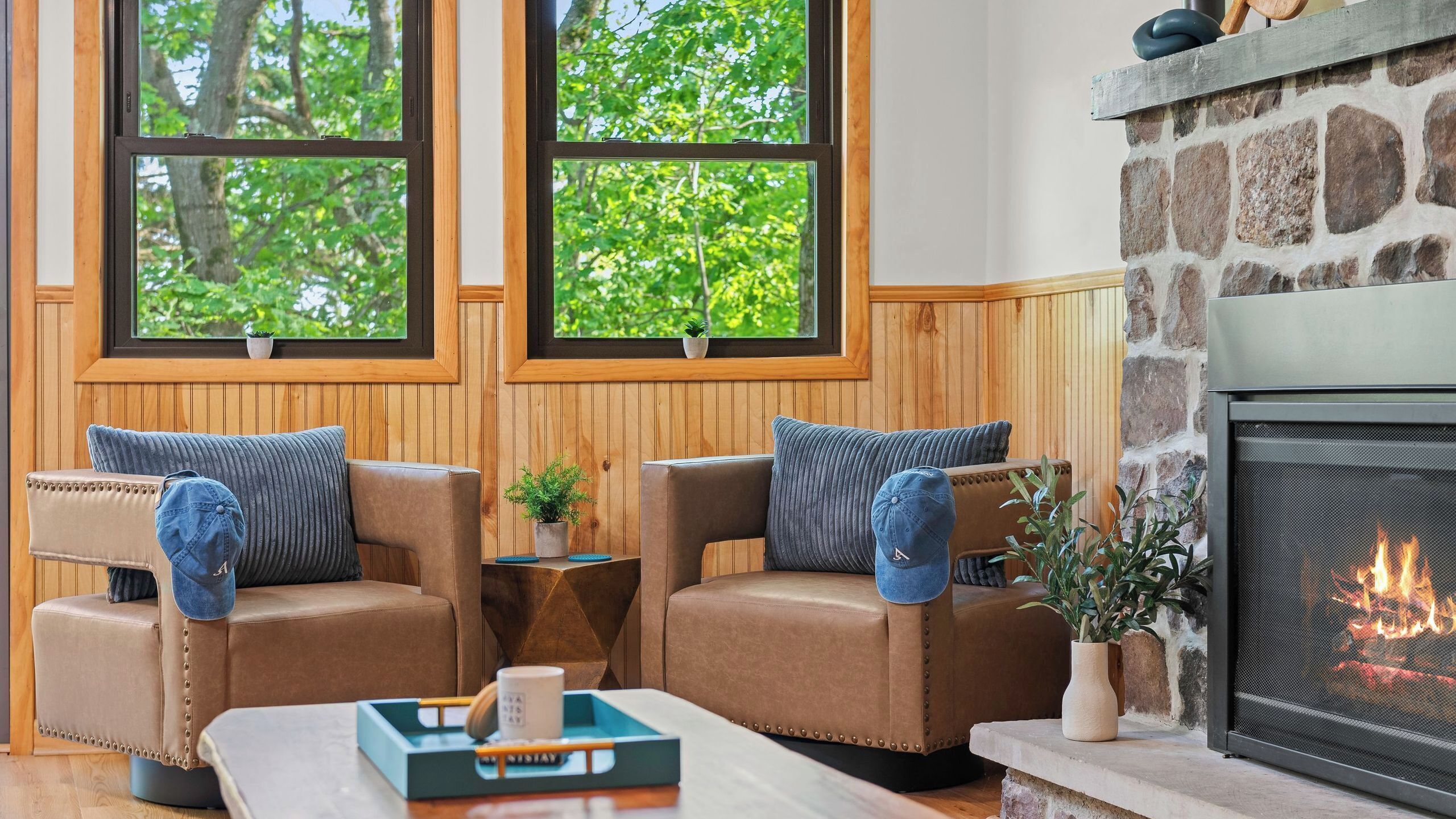 A cozy room with two leather sofas, a coffee table, and a fireplace.