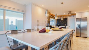 A modern kitchen with a central island, stainless steel appliances, and a view of the city.