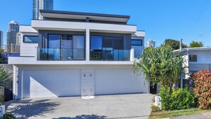 A modern two-story building with large windows and a flat roof.