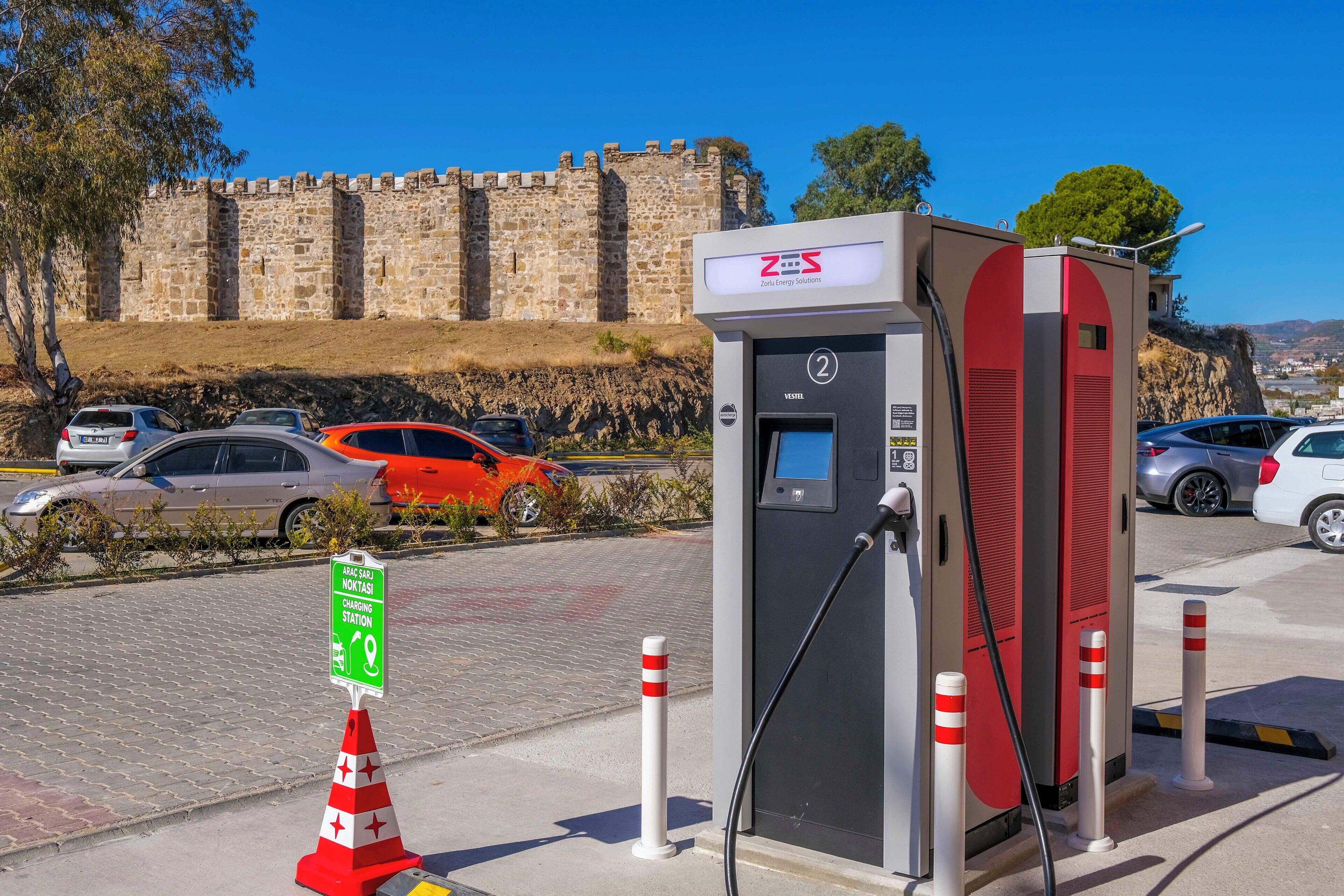 A charging station with a castle in the background.