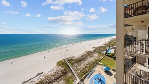 A beachfront hotel with a view of the ocean, a pool area, and multiple balconies. - Phoenix V Vacation Rental Condominiums (Orange Beach)