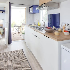 Fridge, microwave, stovetop, dining tables