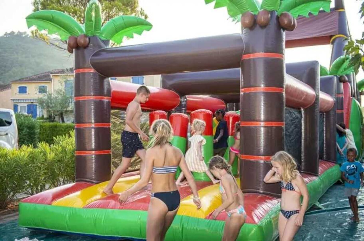An inflatable water park with slides and climbing structures.