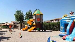 A playground with slides and a climbing structure.