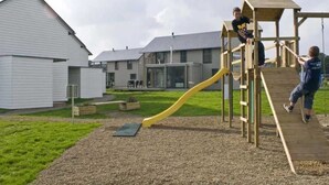 A playground with a wooden slide and climbing structure. - ZEcamping 4* animé locatif TV LV clim 130m2 8 pers (Froidchapelle)
