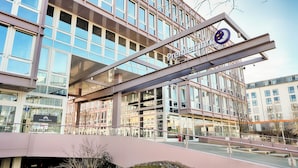 A modern building with a prominent 'Premier' sign and 'Omega offices' sign.