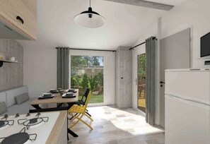 A modern kitchen with a dining area, large windows, and a view of the outdoors.