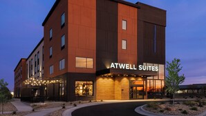 A modern hotel building with a sign reading "ATWELL SUITES." - Atwell Suites Kansas City Airport by IHG (Kansas City)