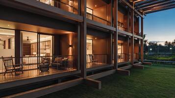 A multi-story building with balconies, outdoor seating, and a well-lit interior.