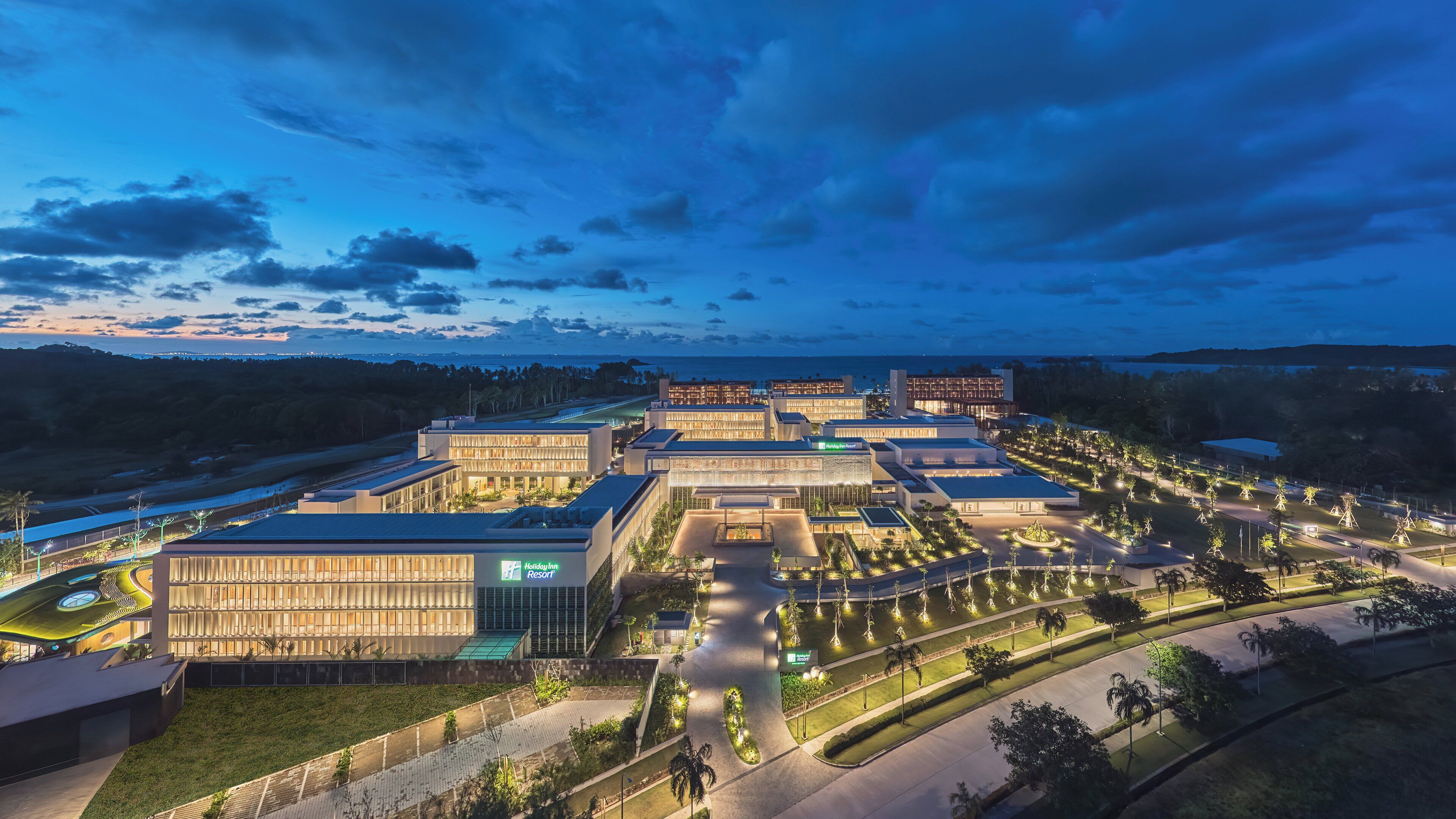 A Holiday Inn Resort with modern architecture, landscaped grounds, and a view of the surrounding area.
