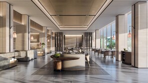Un hall espacioso con una zona de estar central, ventanas amplias y un diseño moderno.
