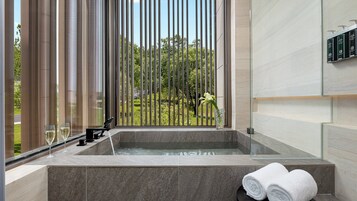 Separate tub and shower, rainfall showerhead, designer toiletries