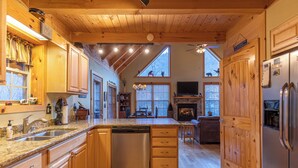 A spacious kitchen with wooden cabinets, a dishwasher, and a large island. - Bear Creek (Sugar Grove)