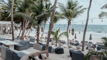 Praia particular, areia branca, guarda-sóis, toalhas de praia