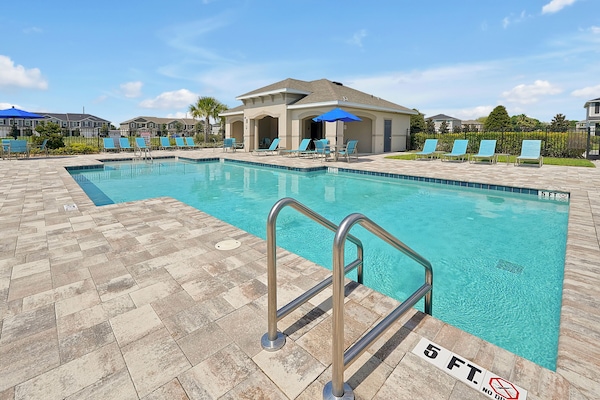 Enjoy the Luxury Community Pool with new paver deck and crystal-clear water.