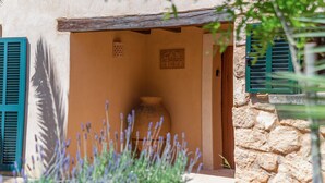 A rustic building with a stone wall, a wooden door, and a sign that reads 'CAN RIERA'. - Holiday Home 'S'hort Des Frares' with Mountain View, Wi-Fi and Air Conditioning (El Palmer)