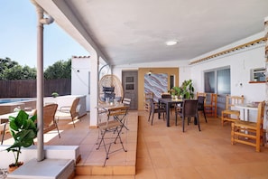 An outdoor patio area with a pool, seating arrangements, and a view of the surrounding landscape. - Villa 'J R Dream House' with Private Pool, Wi-Fi and Air Conditioning (Quarteira)