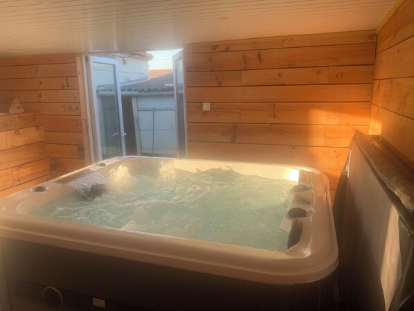 A wooden cabin with a hot tub.