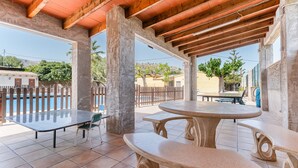 An outdoor patio area with a pool, a table, and benches. - Country House 'La Romana' with Private Pool, Wi-Fi and Air Conditioning (La Romana)