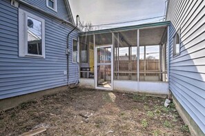 A house with a screened porch, a door leading to a covered area, and a yard with sparse grass. - 5 Mins From Fountain Square ! (Indianapolis)