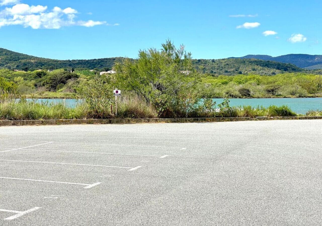 A parking lot with a sign indicating a no-parking zone.