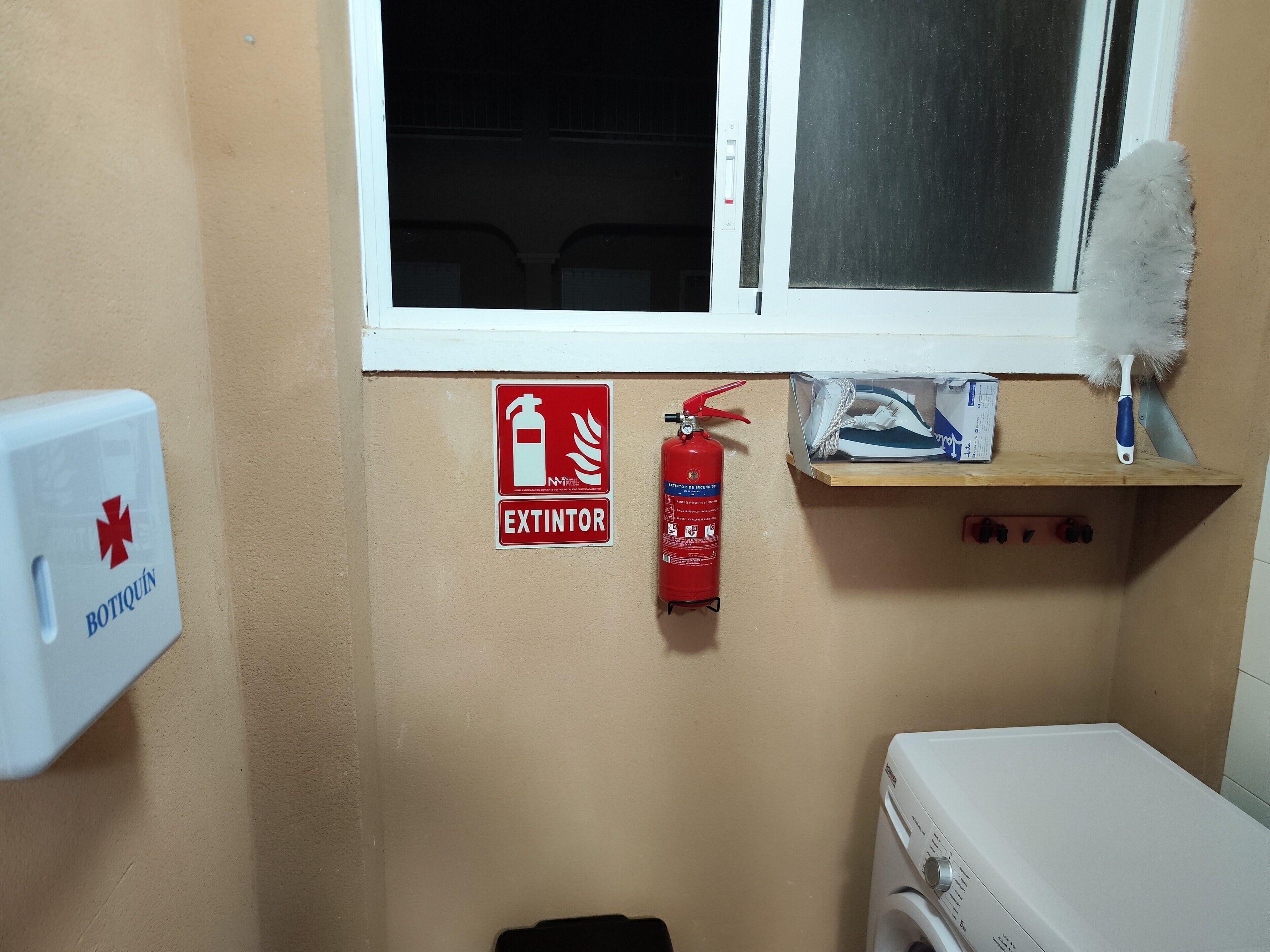 Une salle de bain équipée d’un extincteur, d’une trousse de premiers secours et d’une fenêtre.