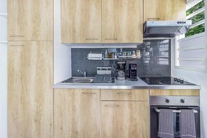 A modern kitchen with wooden cabinets, stainless steel appliances, and a built-in oven.