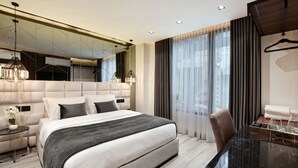 A modern hotel room with a large bed, a glass table, and a mirror above the bed. - Luxury 4BR Villa with Rooftop and Jacuzzis on Lleras Park (Medellín)