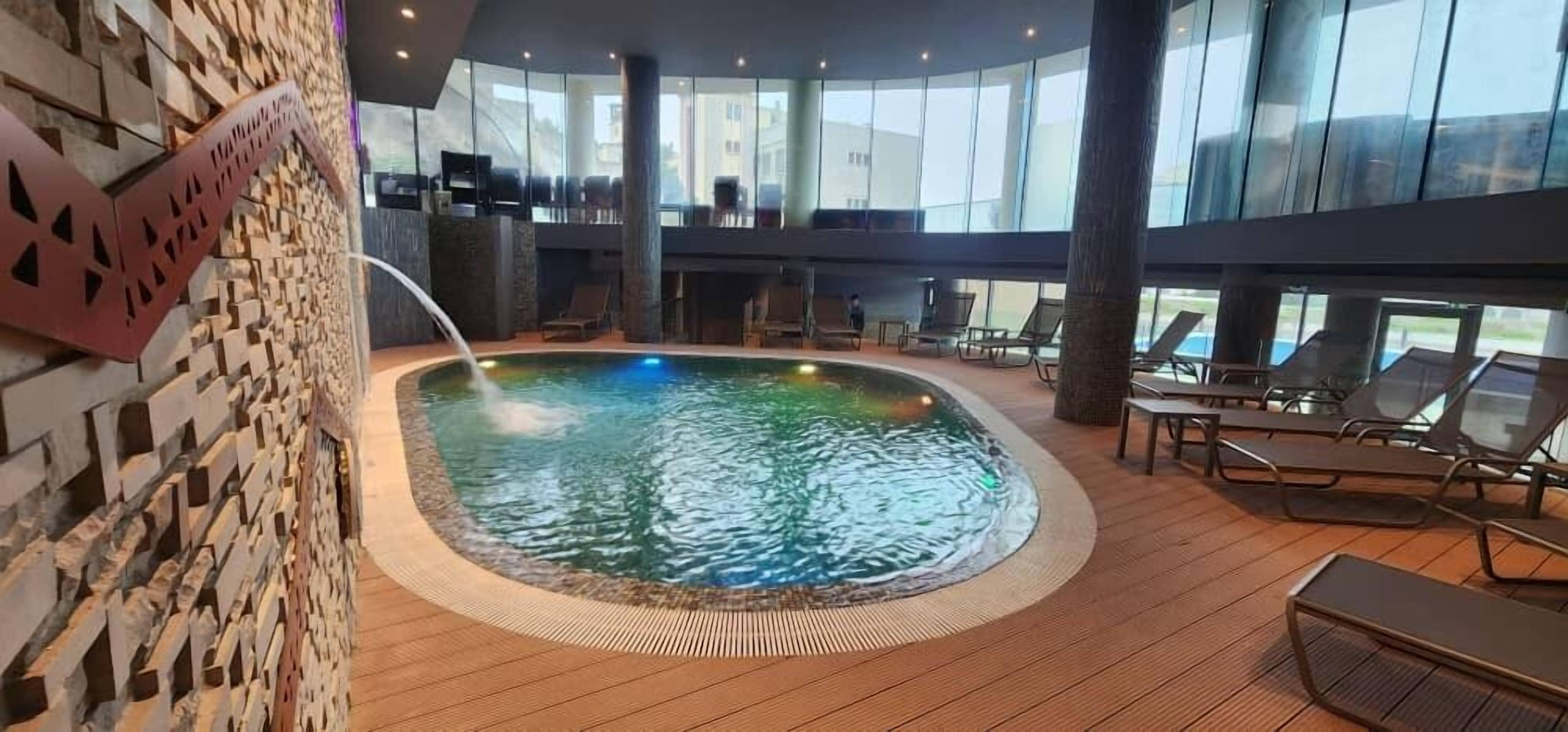 Indoor pool, seasonal outdoor pool, pool umbrellas, sun loungers