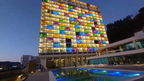 A modern hotel with a colorful facade, a swimming pool, and a flat roof. - Seybouse Hotel & SPA (Annaba)