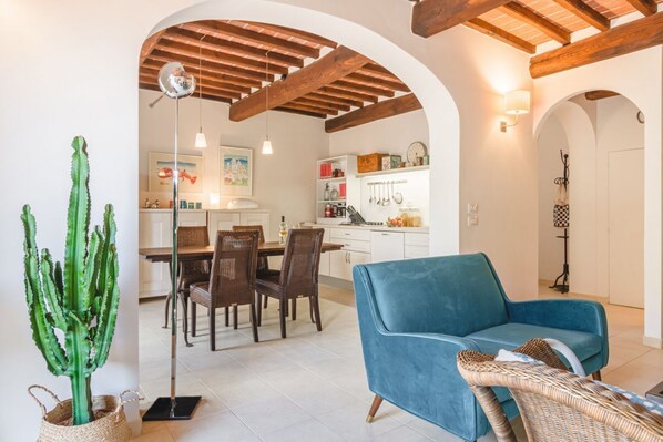 A modern interior with a dining area, kitchen, and living space.
