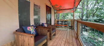 Safari Tent nestled in the woods, creek side, furnished balcony, pet friendly, sleeps 5.