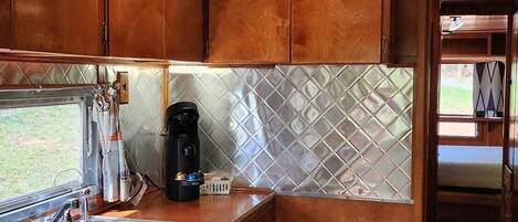 Fridge, microwave, coffee/tea maker, cookware/dishes/utensils