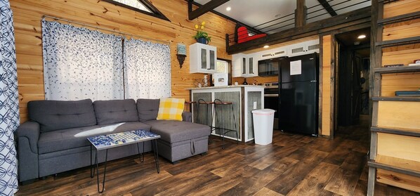 Living area - 2-story tiny home nestled on the creek, quick walk to pool and playground, private firepit, sleeps 7. (Mill Spring)