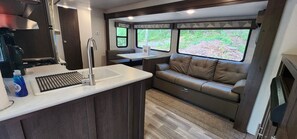 Fridge, microwave, oven, stovetop - Travel trailer near the creek, short walk to pool and playground, sleeps 8. (Mill Spring)