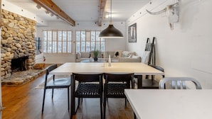A dining area with a stone fireplace, wooden beams, and a cow skull decoration. - Stylish Sun Valley Condo w/ Resort Access! (Sun Valley)
