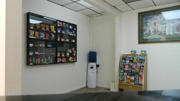 A room with a vending machine, a water cooler, and a bulletin board with various items. - Travel Inn Atlanta (Atlanta)