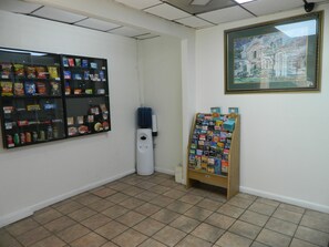 A room with a vending machine, a water dispenser, and a bulletin board with various items. - Travel Inn Atlanta (Atlanta)