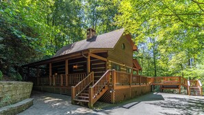 A wooden cabin with a porch, a staircase, and a deck. - Hummingbird Hollow (Banner Elk)