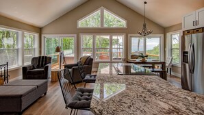 A spacious kitchen with a large island, a dining area with a view, and a cozy seating area with a fireplace. - Lessons from Mars (Banner Elk)