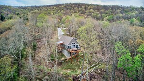 A house with a deck, surrounded by forest. - Lessons from Mars (Banner Elk)